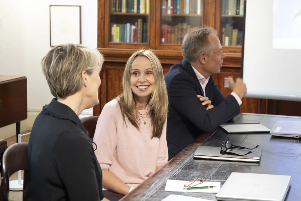 Two women having a discussion in the meeting room.